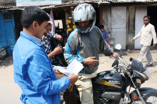ADMIT CARD PLEASE: A member of the Joint Struggle Committee of organisations representing Bahun, Chhetris and Dalits checks the examination admit card of a student to let him through Thursday's banda at Satdobato, Kathmandu.