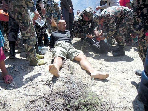 FORTUNATE: Agni Air crash survivor Andreas Rasch from Denmark, receives first aid near the crash site on a mountainside west of Jomsom on Monday. Rasch was one of the six survivors of the crash, 15 were killed.