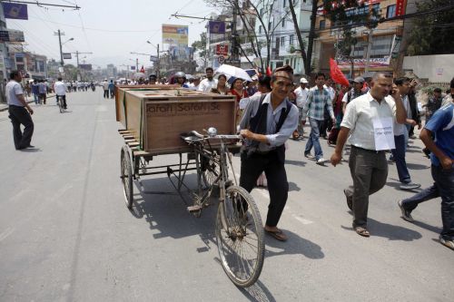 LET'S WORK TOGETHER: A daily wage worker joins a rally organised by student unions of different political parties at Baneshwor on Wednesday, spreading the message of ethnic harmony and peace.