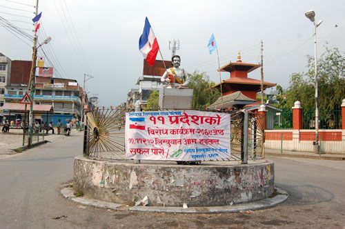 FLAG BEARER: A flag of the Federal Limbuwan State Council planted on the statue of poet Bhanu Bhakta Acharya in Sunsari on Wednesday along with a banner announcing a three-day banda demanding a Limbuwan state.