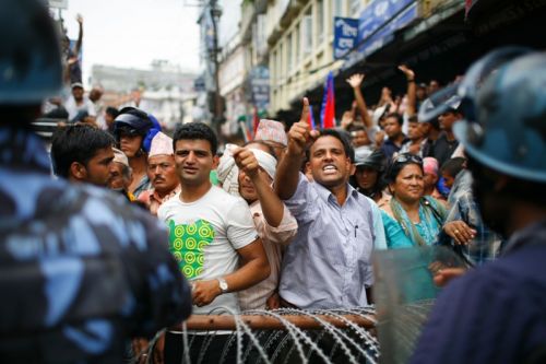 HANDS UP: Protestors outside the CA building in Baneshwor on Sunday, the day the constitution deadline expires. Security personnel have been deployed outside the building as various groups stage protests. Discussions are underway in Baluwater but a conclusion is yet to be reached.