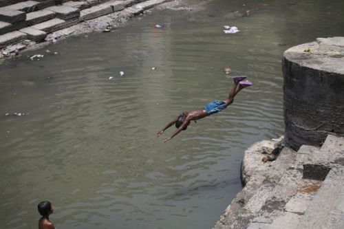 SUMMER SPLASH: A local boy dives into the Bagmati River at Pashupati this week as the tempreture rises in the Valley.