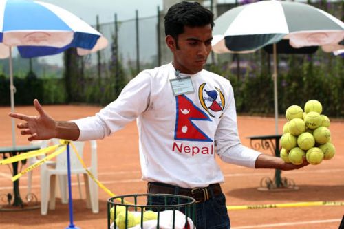Rohit Timilsina attempts to break the Guinness Book of World Records in 'Holding 21 tennis balls for 14 seconds 34 miliseconds at the All Nepal Lawn Tennis Association, Satdobato on14th June.The record is currently held by Mr. Arunad Deschamps of France, who has the record of holding 19 Lawn Tennis balls for 10 seconds.