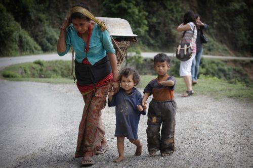LAUNDRY DAY: A woman carries washed clothes back to her house from a community tap in Kakani, Nuwakot on Sunday.