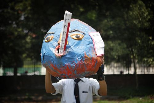 TEMPRETURE RISING: A student holds a paper globe to show effects of global warming during a program organised to mark the World Environment Day in Kathmandu on Tuesday.
