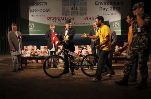 LEAD THE WAY: PM Baburam Bhattarai receives a bicycle from the Kathmandu Cycle City 2020 at a program organised to mark the World Environment Day in Kathmandu on Tuesday. The group has been advocating for a separate cycle lane in the capital.
