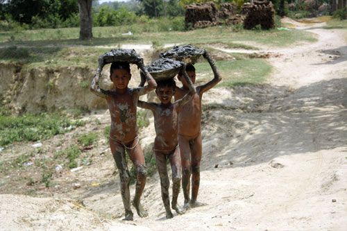 MUD BY MUD: Children transport mud to rebuild their fire-gutted house in Siraha's Aurhi village. The fire spread over an area of 3 km, destroying over 470 houses.