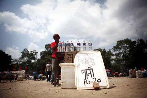 CASHING IN: A local boy sells mineral water at Khula Manch, while crowd gathers on Saturday afternoon for a mass meeting organised by RPP-N.