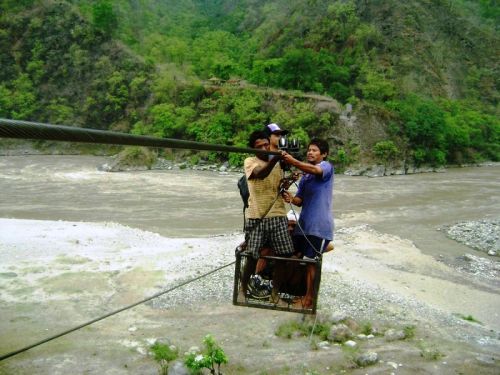 HANGING ON FAITH: Locals cross the Tamor River using a rope way in Dhankuta on Saturday.