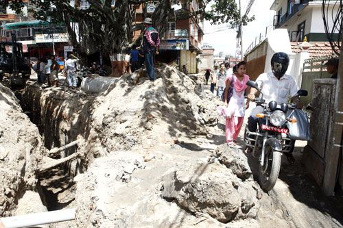 DIRT RIDE: A motorbikes struggles through Kalikasthan road which is under construction on Tuesday.