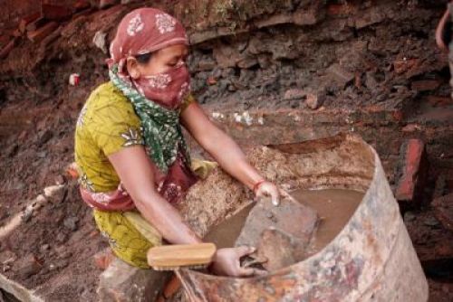 BEAUTIFYING BRICKS: A woman washes bricks, which will be used for renovation of a temple in Basantapur. PIC