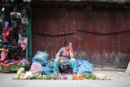 LONG WAIT : A vegetable vendor in Mangalbazaar awaits customers on Wednesday evening PIC