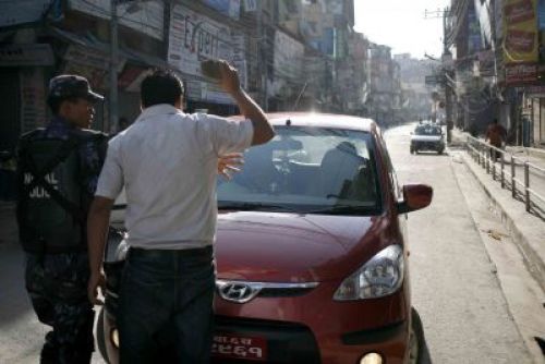NO ENTRY: A policeman stops a protestor who is about to hurl a brick at a private car during the transport strike called by the Youth Association Nepal (YAN), a sister wing of CPN-UML, on Sunday morning.