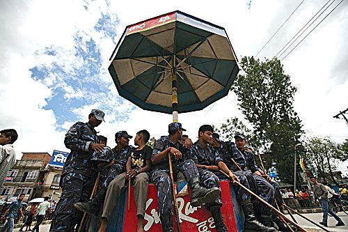 STRIKE RESPITE: Security forces at Satdobato take a break on Thursday during a Lalitpur banda called by the Nepali Congress to protest Minister for Forests Matrika Prasad Yadav's locking up of a Local Development Officer on Tuesday night.