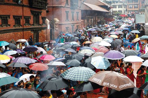 UNDER MY UMBRELLA: Devotees line up near Krishna Mandir in Patan on the occassion of Krishna Janmasthami on Thursday.