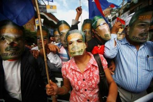 TWO FACED: Members of UML affiliated Youth Association Nepal wear masks of PM Bhattarai during a protest rally at Bagbazaar on Monday and demand for his immediate resignation