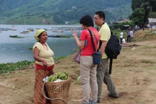 TWO MORE: Tourists bargain with a fruit vendor at Lakeside, Pokhara on Monday afternoon. PIC