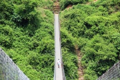 I WALK ALONE: A villager crosses the bridge over Trishuli river in Pida, Dhading.PIC