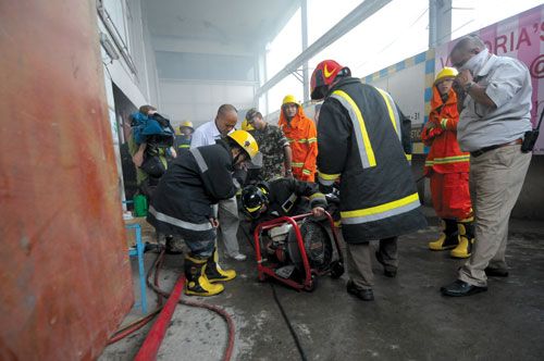 FIGHTING FLAMES: Firefighters trying to douse the flame at the basement of City Centre, which caught on fire after a generator short-circuited on Wednesday afternoon.
