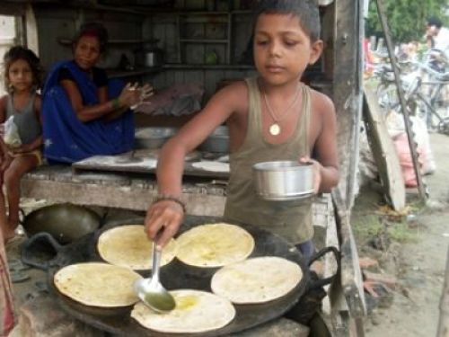 CHILD AT WORK: A young boy makes roti at a street side eatery in Itahari. PIC