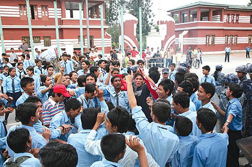 EDUCATION BLUES: Uniformed students burned tyres and vandalised vehicles on Monday as they protested high bus fares outside the Education Ministry. The nearby western gate of the former royal palace, which used to be out of bounds for rallies, was also affected.