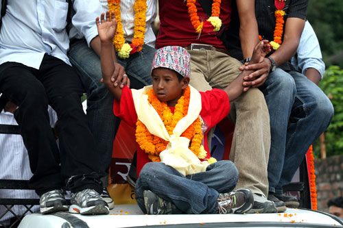 YOUNG HERO: Kamal Nepali is taken around the streets of capital after risking his own life to rescue a three-year-old girl trapped in a sinkhole in Pokhara.