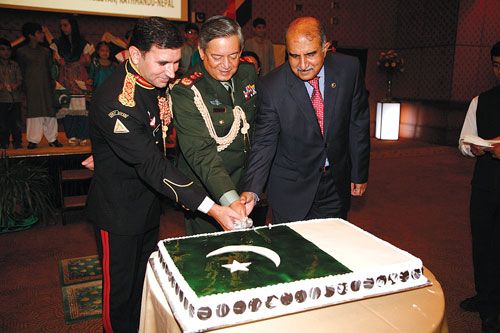 PAKISTANI PIECE OF CAKE: Arshed Saud Khosa, ambassador of Pakistan (right), cuts a cake during his country's Defense Day with Commander in Chief of Nepal Army, Gaurav Shamsher Rana (middle), and Pakistani Colonel Mumtaz Hussain (left) on Saturday at the Hyatt.