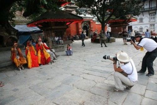 TOURISTS DAY: International travellers take photos of ascetics, a big attraction in Kathmandu Durbar square, today, while the world celebrates Tourism Day.