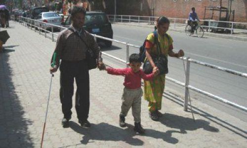 HELPING HAND: A seven year boy guides his blind parents near Thamel, Kathmandu. The family is originally from Charikot District.