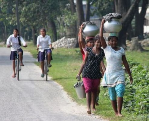 DASAIN DECORATION: Young girls from Charali, Jhapa take buckets of black mud which they collected from a nearby forest back home. Families in Jhapa paint their houses with black mud before Dasain.