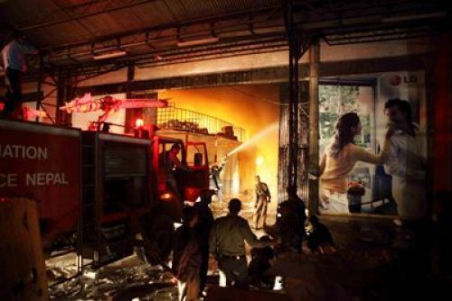 TOUGH JOB: Fire fighters try to bring the raging inferno at the Chaudhary Group Electronics factory under control. Five fire engines from the Juddha Barun Yantra were deployed to the factory.