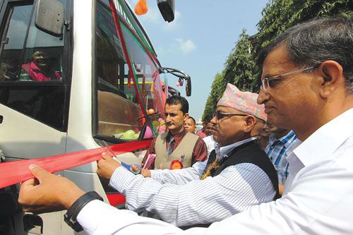 COACH ON BOARD: Jhapa CDO Narendra Raj Sharma inaugurates three luxurious buses that will serve Kathmandu-Kakarvitta route on Kathmandu on Monday.
