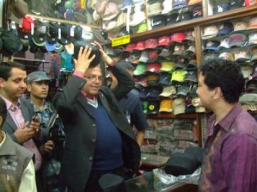 LAST-MINUTE SHOPPING: CPN-UML Chairman Jhala Nath Khanal goes also shopping on Dasain and tries a Nepali Topi at Massangalli, Kathmandu, Saturday morning.