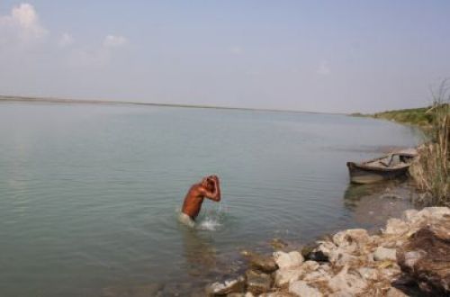 REWARD: A fisherman takes a bath after a long day's work, in the Koshi River in Saptari district.
