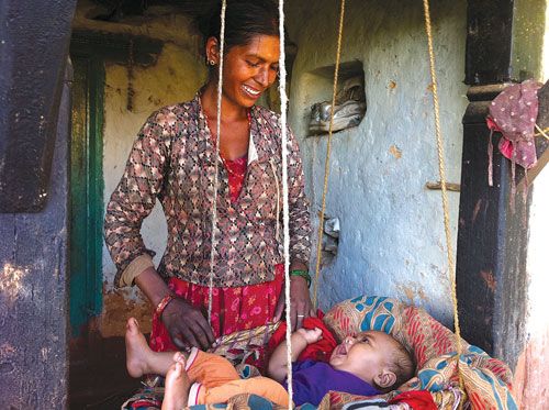 JOLLY SWING: A happy mother looks after her newborn in Thok, Sanga Chok VDC, Sindhupalchok.