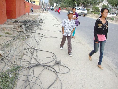 CATASTROPHE CALL: Although road construction is nearly finished in Maharajganj, electric and telephone wires have been left down on the sidewalks.