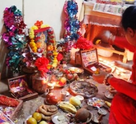 FORTUNE: A woman worships goddess Laxmi on Tuesday evening at her home.