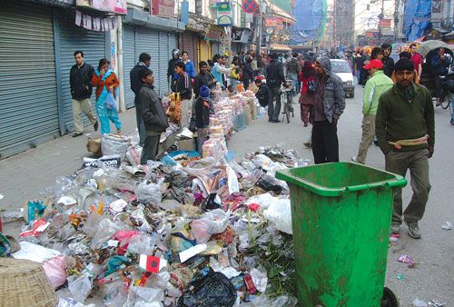 BUILDING UP: Street vendors sell their goods next to a pile of garbage in Maru Tole, New Road on Tuesday which has not been collected due to the festivities.