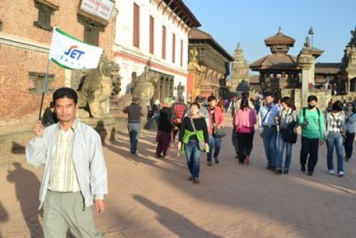 THIS WAY PLEASE: A tourist guide leads Korean tourists around Bhaktapur Darbar Square on Monday.