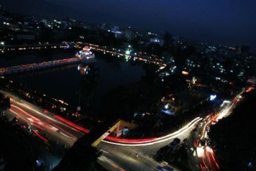 NIGHT VIEW: Government leaders and people from the neighbourhood gathered around Ranipokhari to do a special puja at sunset on Monday. .