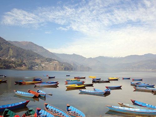 ROCKING BOATS: Boats await customers on the bank of Phewa Lake on a peaceful afternoon.