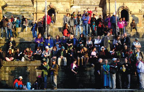 WATCHING YOU: Tourists gather on the banks of the Bagmati opposite the cremation site in Pashupatinath to observe and take pictures of funerals on Wednesday afternoon.