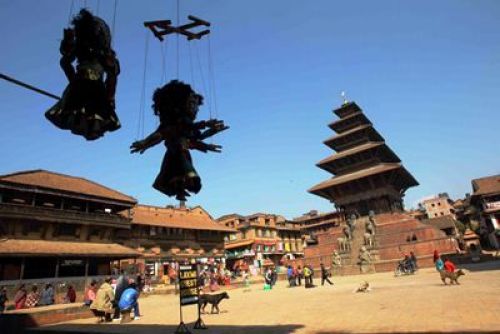 GUARDS ON-DUTY: Traditional wooden puppeteers seem to watch Nyatapola temple in Bhaktapur on Friday.