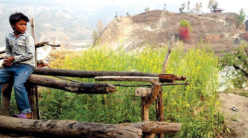 LOOKING FOR THE FUTURE: A boy takes a break after spending an entire day taking care of trekkers' horses in Dhading district.