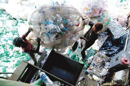 A NEW LOOK: Workers bring a huge bag of old plastic bottles to a recycling factory in Balkumari, Lalitpur on Wednesday afternoon. The bottles are crushed and sold to soft drink companies.
