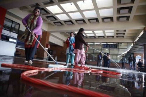 CLEAN N CLEAR:Women wash the floors at Tribhuwan International Airport on Friday afternoon.