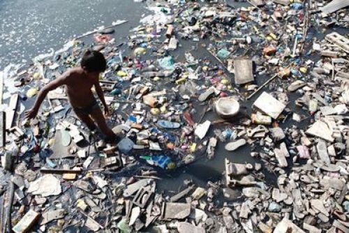 OPEN-ENDED CYCLE: A young boy looks for empty plastic bottles in Bagmati River to sell them later for recycling in Kathmandu Valley, Tuesday afternoon.