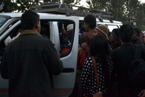ME FIRST: The driver of a micro-bus watches as passengers compete to get inside his vehicle at New Baneswor on Tuesday.