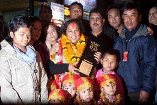 WE DID IT!: CNN Hero 2012 Pushpa Basnet poses for photographers at her arrival at Tribhuvan International Airport in Kathmandu, Saturday evening.