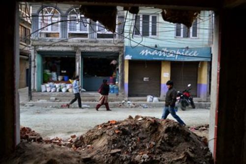 SCRAPYARD: People walk past the roadside debris of a house under demolition near Kamalpokhari on Wednesday.